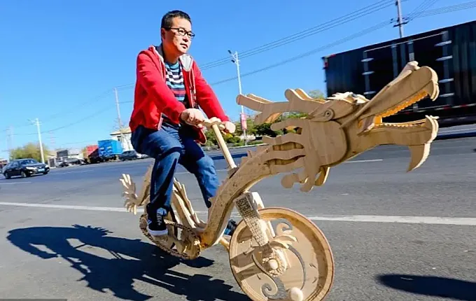 Un chino fabrica una bicicleta con palitos de helado y forma de dragón
