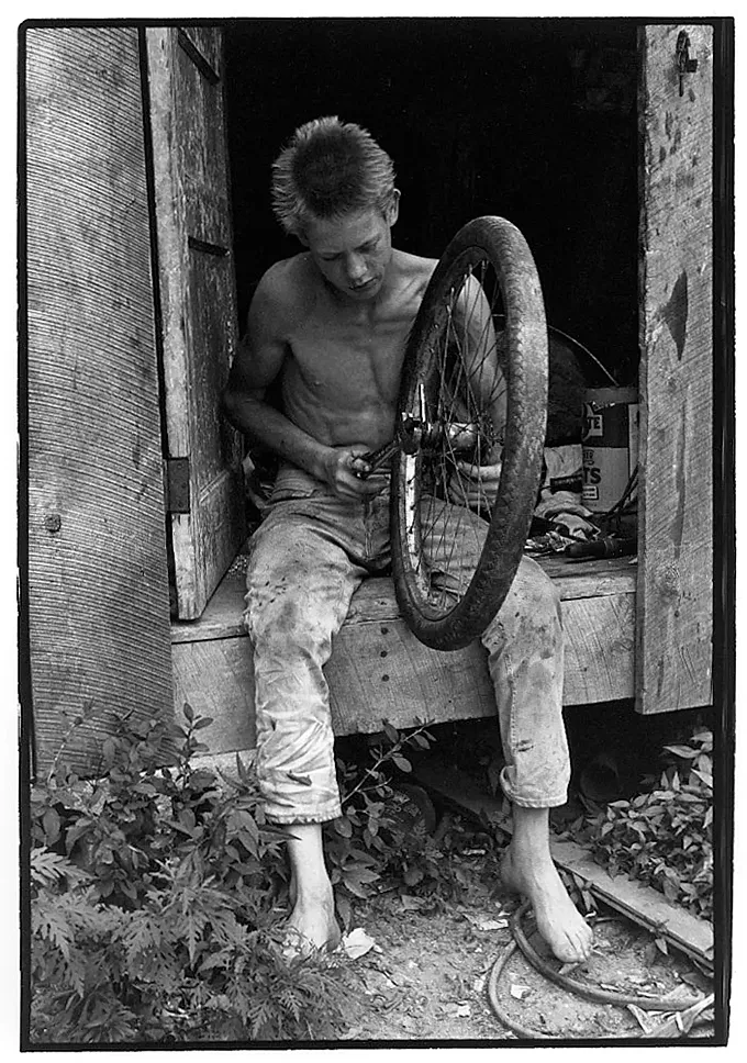 'Boy fixing a bicycle tire', William Gedney (1964)